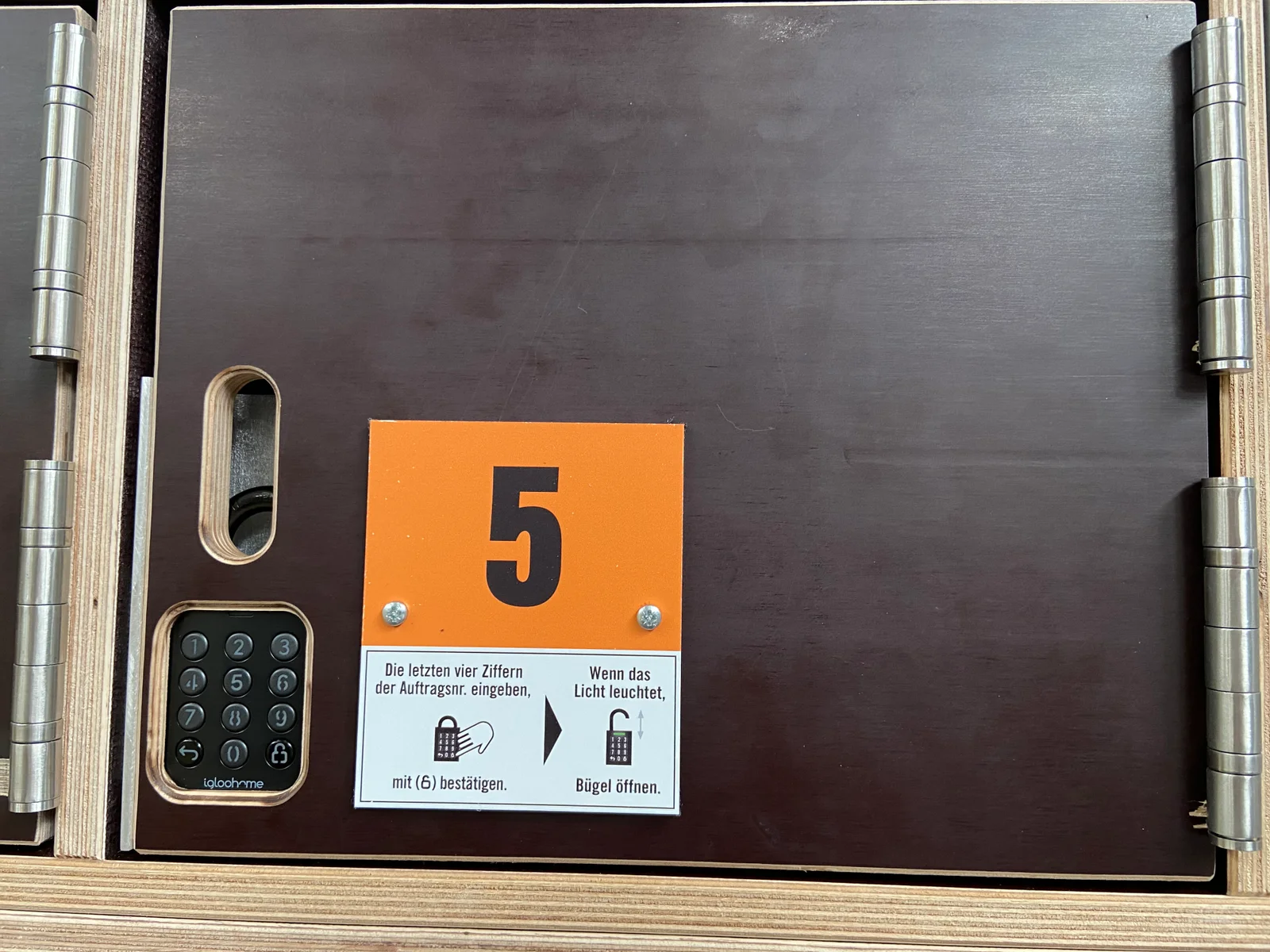 Close-up of an igloohome connected keypad lock installed on Hornbach collection compartment number five