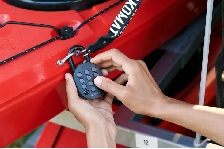 Customer entering a code on connected access hardware attached to a kayak
