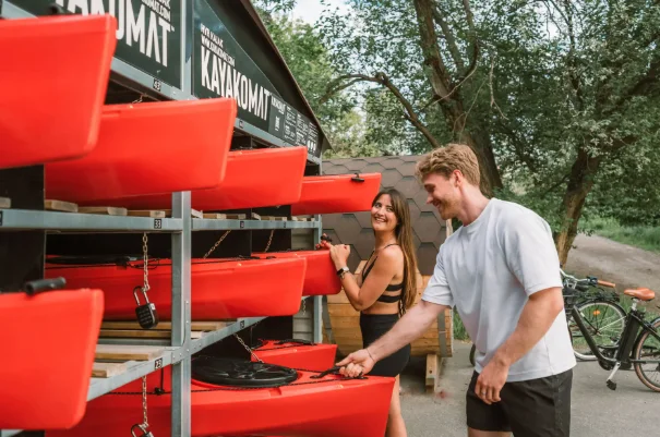 Customers unlocking kayaks at a Kayakomat station